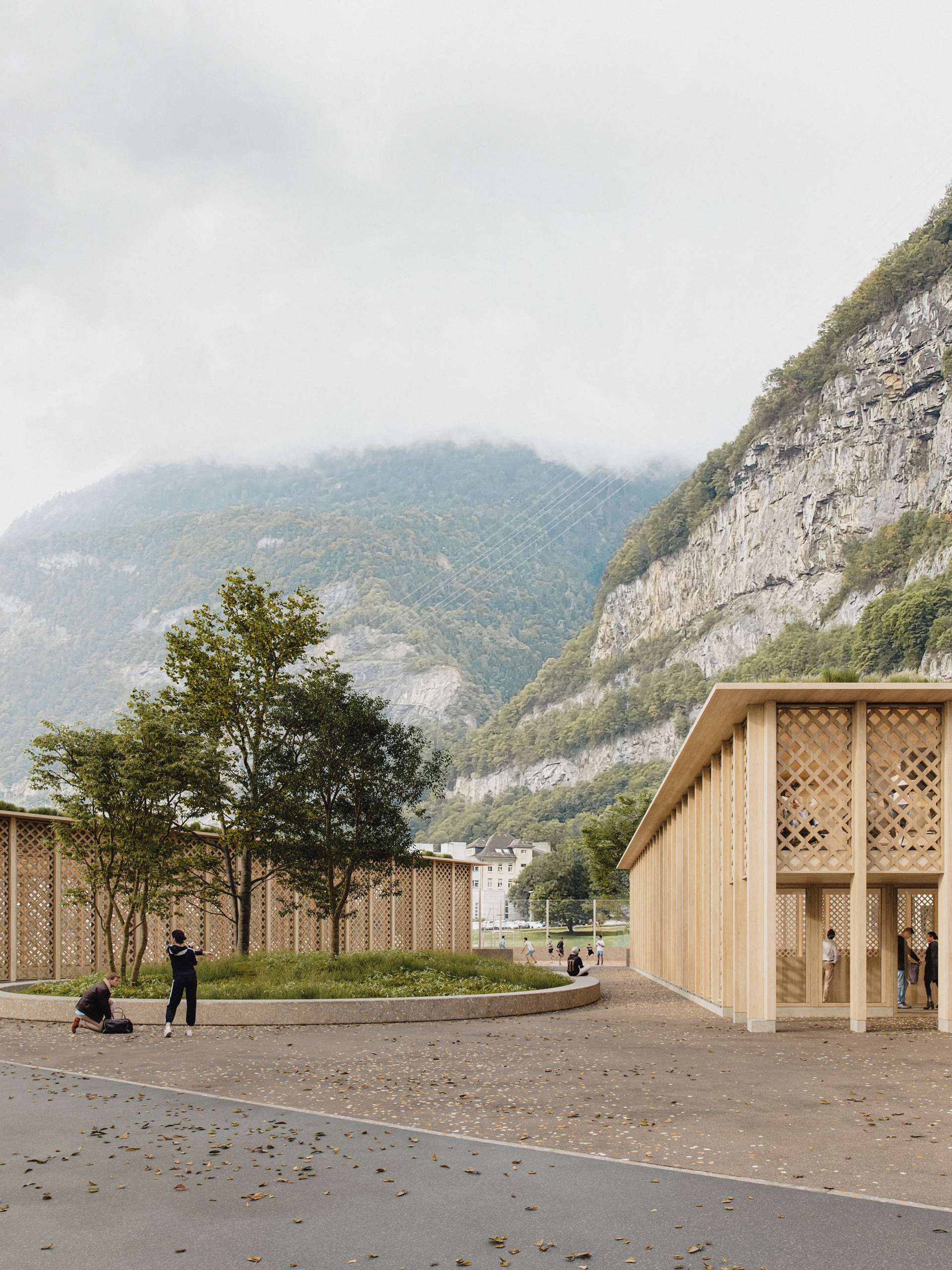 3D rendering of two timber gymnasium buildings framing a view of the Alps