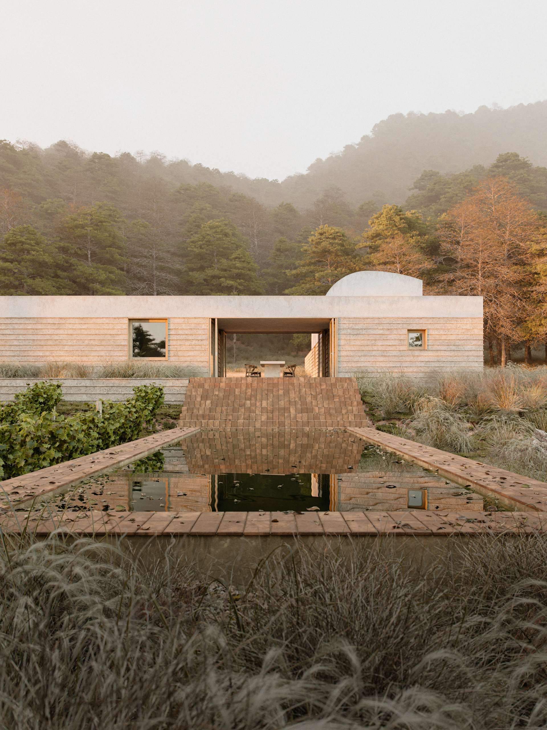 3D rendering of a low stone house set among dry-stone walls on a wooded hillside